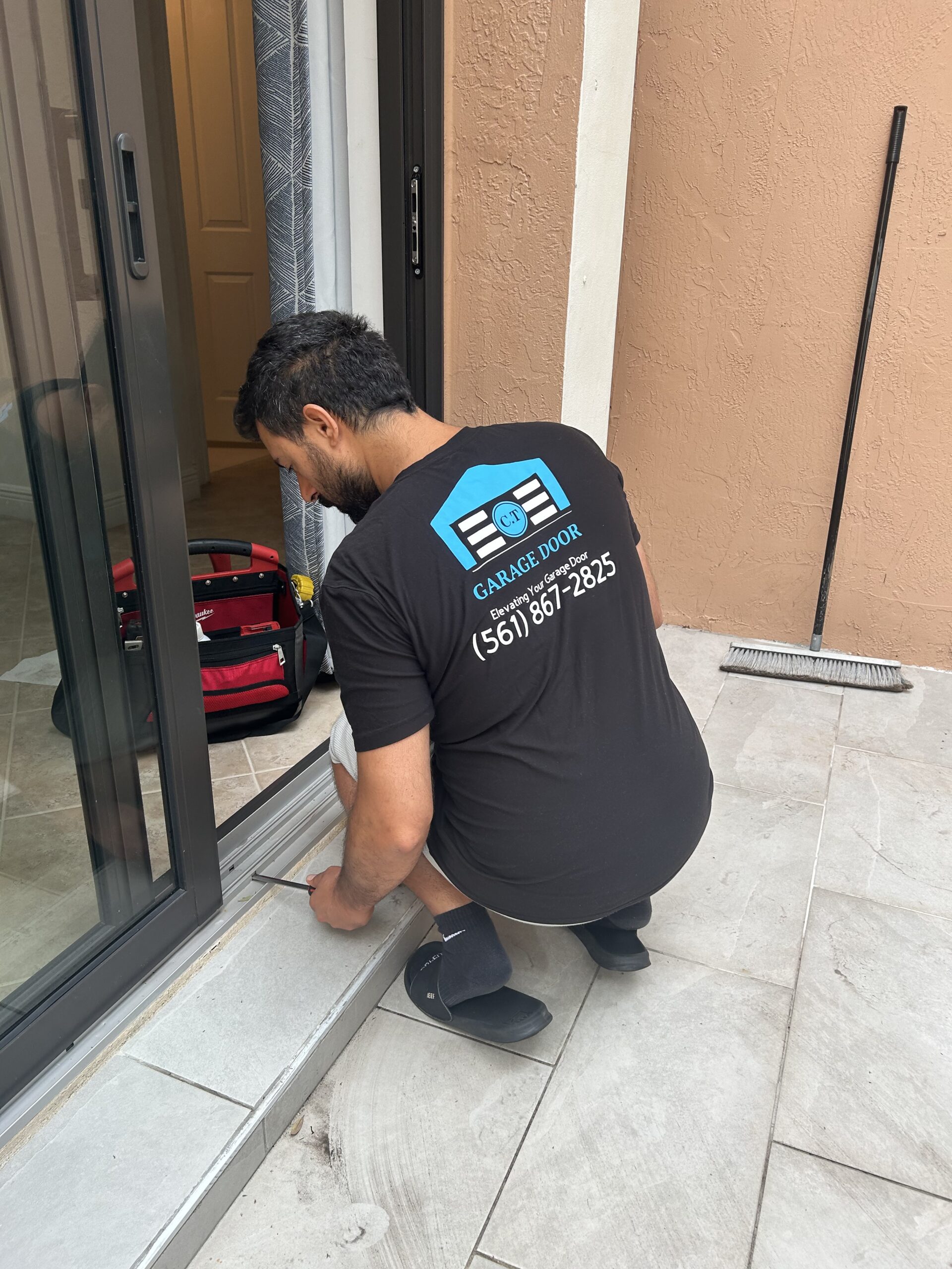 Technician replacing sliding door rollers in Juno Beach, FL
